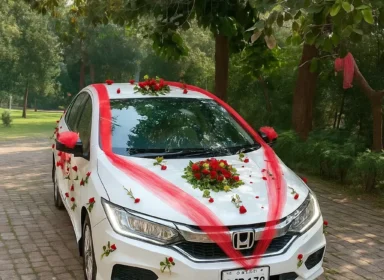 Lahore Blooms red ribbon and roses bridal car decoration