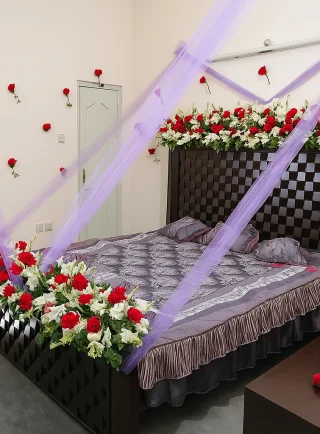 Purple Net & Red Roses Wedding Room Decoration – Classic Bed Setup