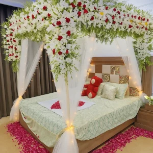 Lahore Blooms white canopy wedding room decoration with heart petals and teddy