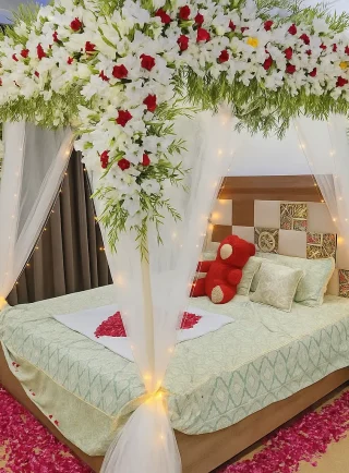 Lahore Blooms white canopy wedding room decoration with heart petals and teddy