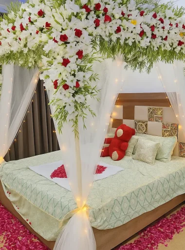 Lahore Blooms white canopy wedding room decoration with heart petals and teddy