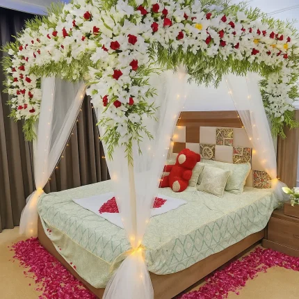 Lahore Blooms white canopy wedding room decoration with heart petals and teddy