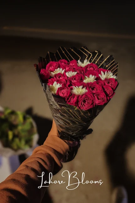 Compact pink rose bouquet with white flowers in black wrapping – Lahore Blooms