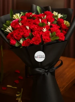 Red roses bouquet with greenery in matte black wrapping and black ribbon – Lahore Blooms