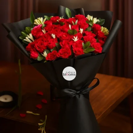 Red roses bouquet with greenery in matte black wrapping and black ribbon – Lahore Blooms