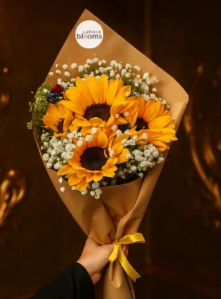 Sunflower bouquet with baby’s breath wrapped in kraft paper and yellow ribbon – Lahore Blooms