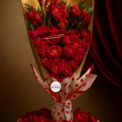 Romantic red roses bouquet with golden wrap and heart-printed paper – Lahore Blooms