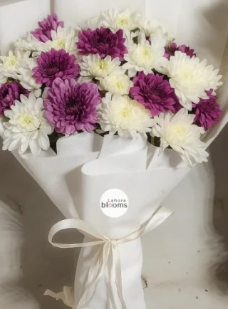 Purple and white chrysanthemum bouquet wrapped in white paper with ribbon – Lahore Blooms