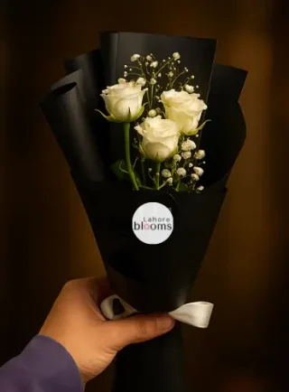 Mini bouquet of white roses with baby’s breath in matte black wrapping – Lahore Blooms