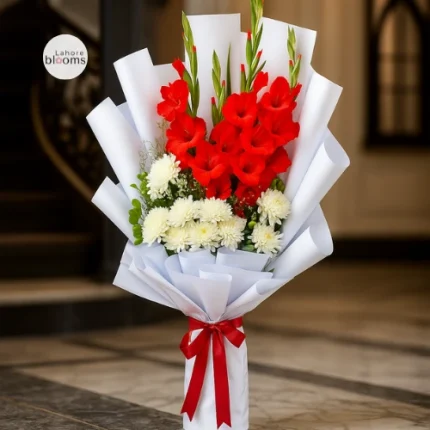 Tall red gladiolus and white chrysanthemum bouquet wrapped in white paper with red ribbon – Lahore Blooms