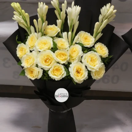 Yellow roses and white tuberose bouquet in black wrapping – Lahore Blooms