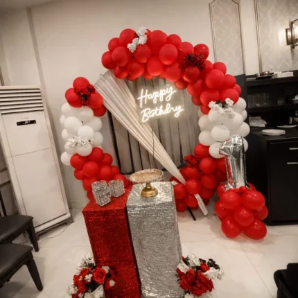Red & White Birthday Balloon Arch Setup – Neon Sign, Sequin Cake Table & Fresh Flowers