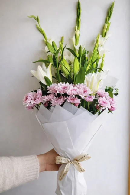 white lily and pink carnation bouquet in lahore elegant wrapped flowers
