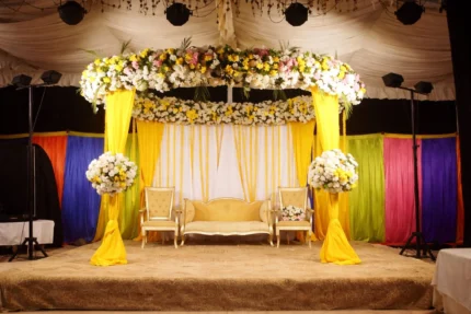 Elegant mayon canopy decoration in Lahore with yellow theme and floral stage setup