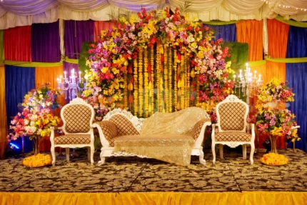 Traditional mayon stage decoration in Lahore with floral backdrop and seating