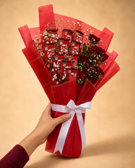 Birthday chocolate bouquet with KitKat bars, red roses, baby's breath, red wrapping and white satin ribbon
