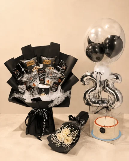 Luxury birthday gift for him with black snack bouquet, white roses, cake in acrylic box, silver number balloons and black and white balloons