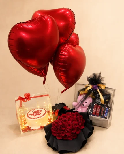 Luxury birthday surprise with large red rose bouquet, illuminated cake box, pink teddy bear, assorted chocolates and red heart balloons