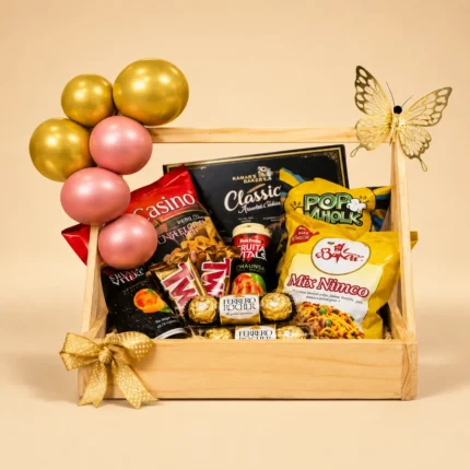 Wooden birthday snack hamper with chocolates, cookies, nimco, savory snacks, pink and gold balloons and decorative butterfly