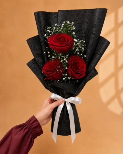 Scarlet Pearl red rose bouquet with baby’s breath in black wrapping in Lahore