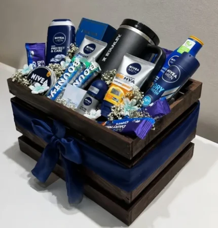 Wooden birthday hamper for him with black tumbler, assorted Nivea Men grooming products, chocolates, fragrance and floral accents