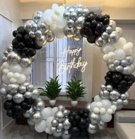Black white and silver balloon birthday decoration with circular arch and Happy Birthday neon sign in Lahore