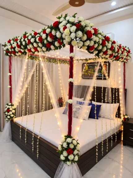 Artificial canopy flowers with fresh marjoram greenery and hanging fresh tuberose strings in a Lahore bridal bedroom