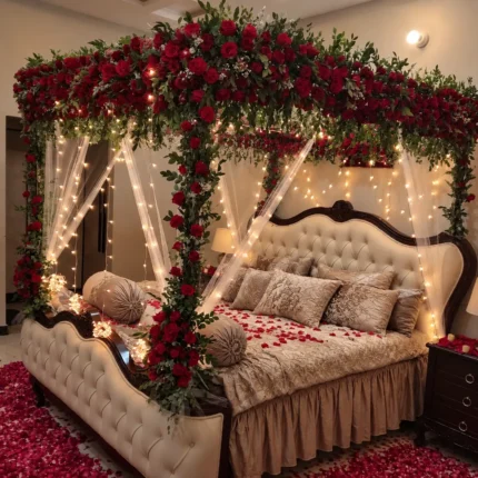 Fresh red flowers and fresh greenery carried down the canopy posts as well as across the overhead frame in a Lahore bridal bedroom