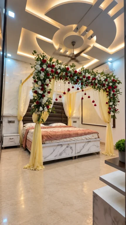 Fresh imported roses in a red-and-white canopy pattern around the top of the bridal bed in a Lahore bridal bedroom