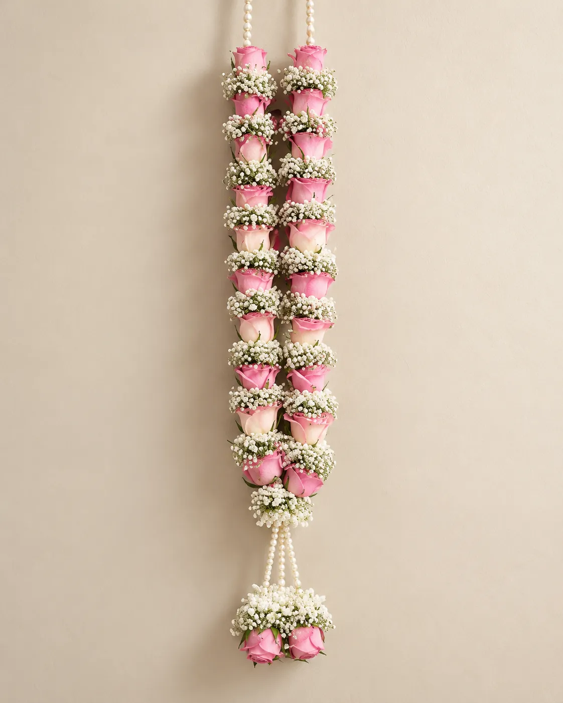 Blush Rose Pearl Tassel Wedding Garland Pink roses spaced with white filler flowers, finished with pearl-style cords and a pink rose tassel.