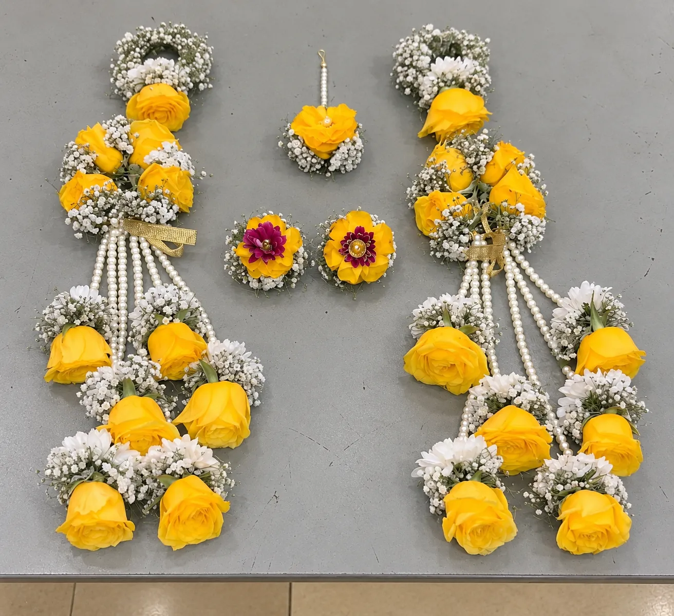 Golden Rose Bridal Kalire Jewellery Set Yellow roses with white filler flowers, cascading pearl-style strands and rose drops on the wrist kalire.