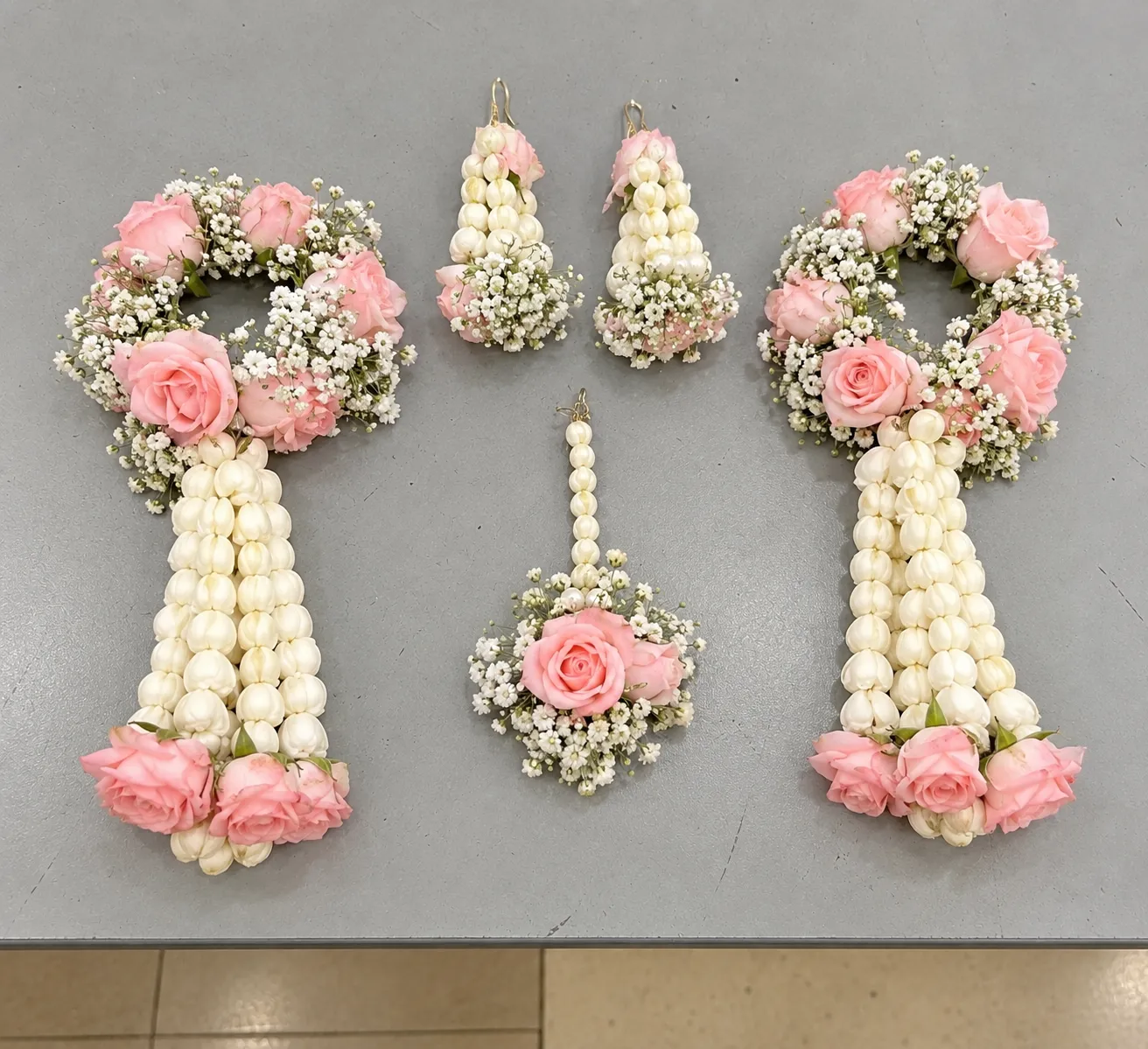 Pink Rose Bridal Kalire Jewellery Set Pink roses with white buds and filler flowers, long white floral strands finish the two wrist kalire.
