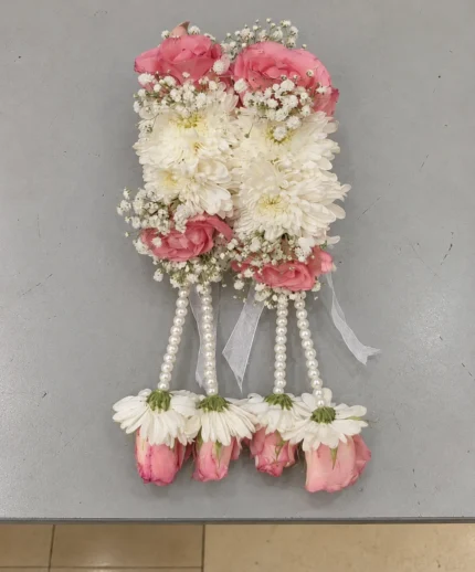Pink roses and white blooms with hanging pearl-style strands and floral drops.