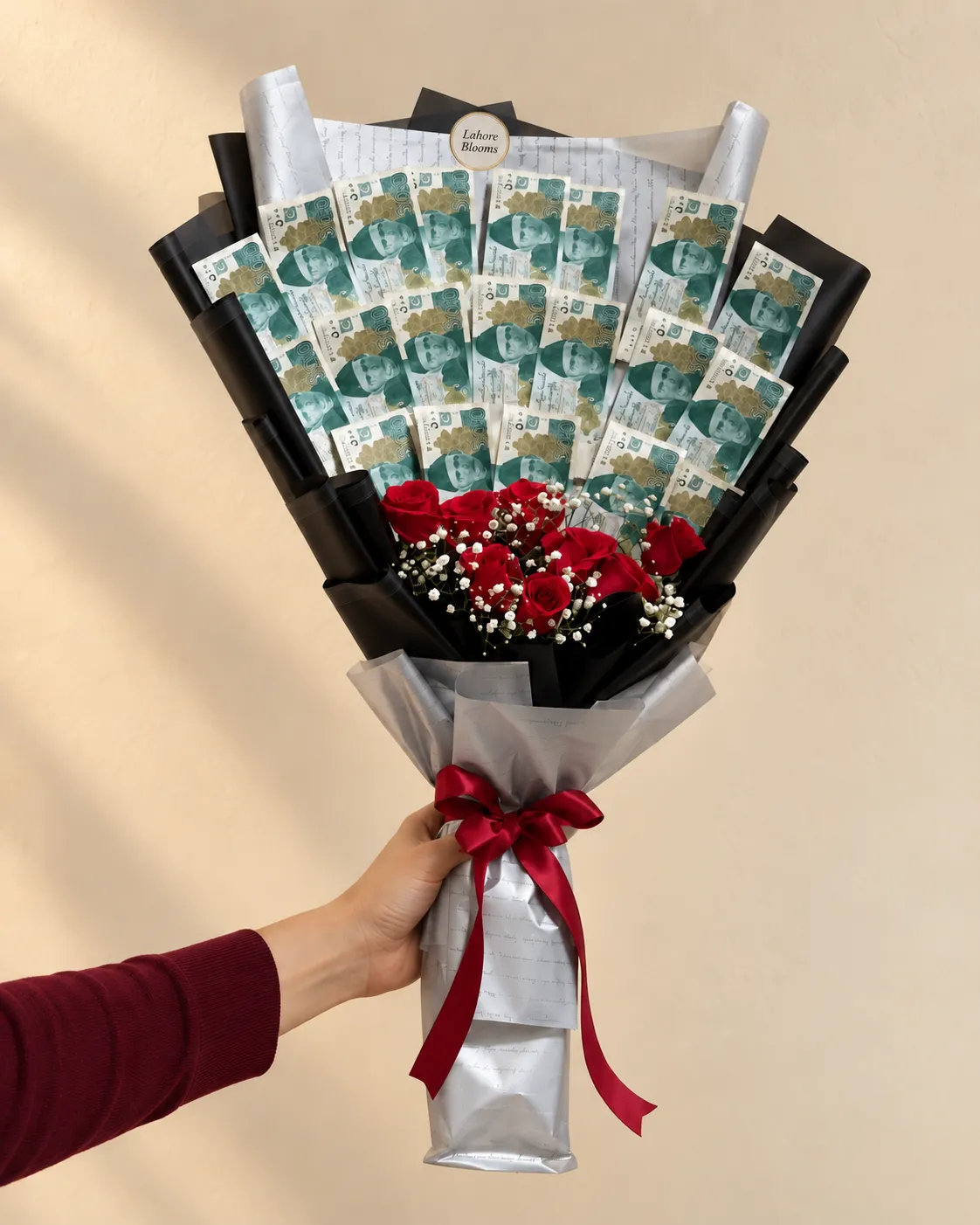 Red Rose Money Fan Bouquet An upright banknote fan above red roses in black and silver wrapping.
