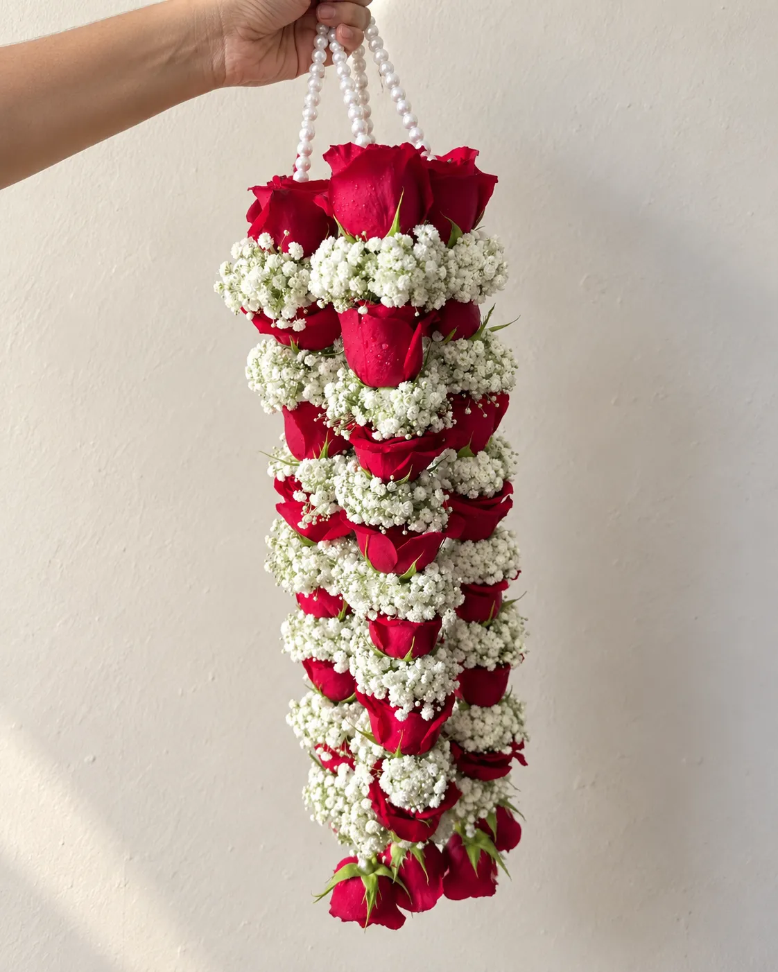 Red Rose and Baby’s Breath Wedding Garland Dense red rose bands alternating with white baby's breath, with pearl-style top cords and red rose drops.